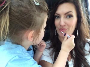 Vivian helping mommy apply her lipgloss